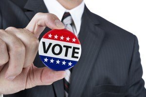 Man holding vote button